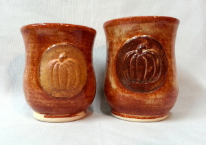 Stoneware tumbler glasses with pumpkins in orange glaze